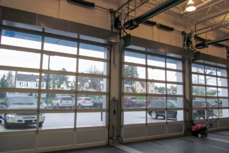Berner's Industrial Direct Drive 12 and 14 Air Curtains over car dealership garage doors