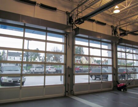 Berner's Industrial Direct Drive 12 and 14 Air Curtains over car dealership garage doors