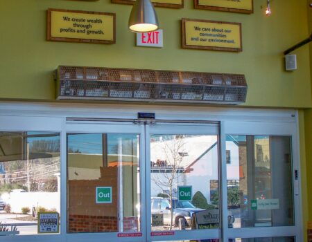 Berner's Sanitation Certified High Performance 7 Air Curtain mounted over grocery store main entrance