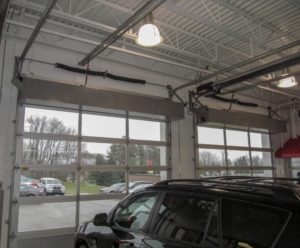 Berner's Industrial Direct Drive 12 Air Curtains over Mel Grata car dealership's service garage doors.