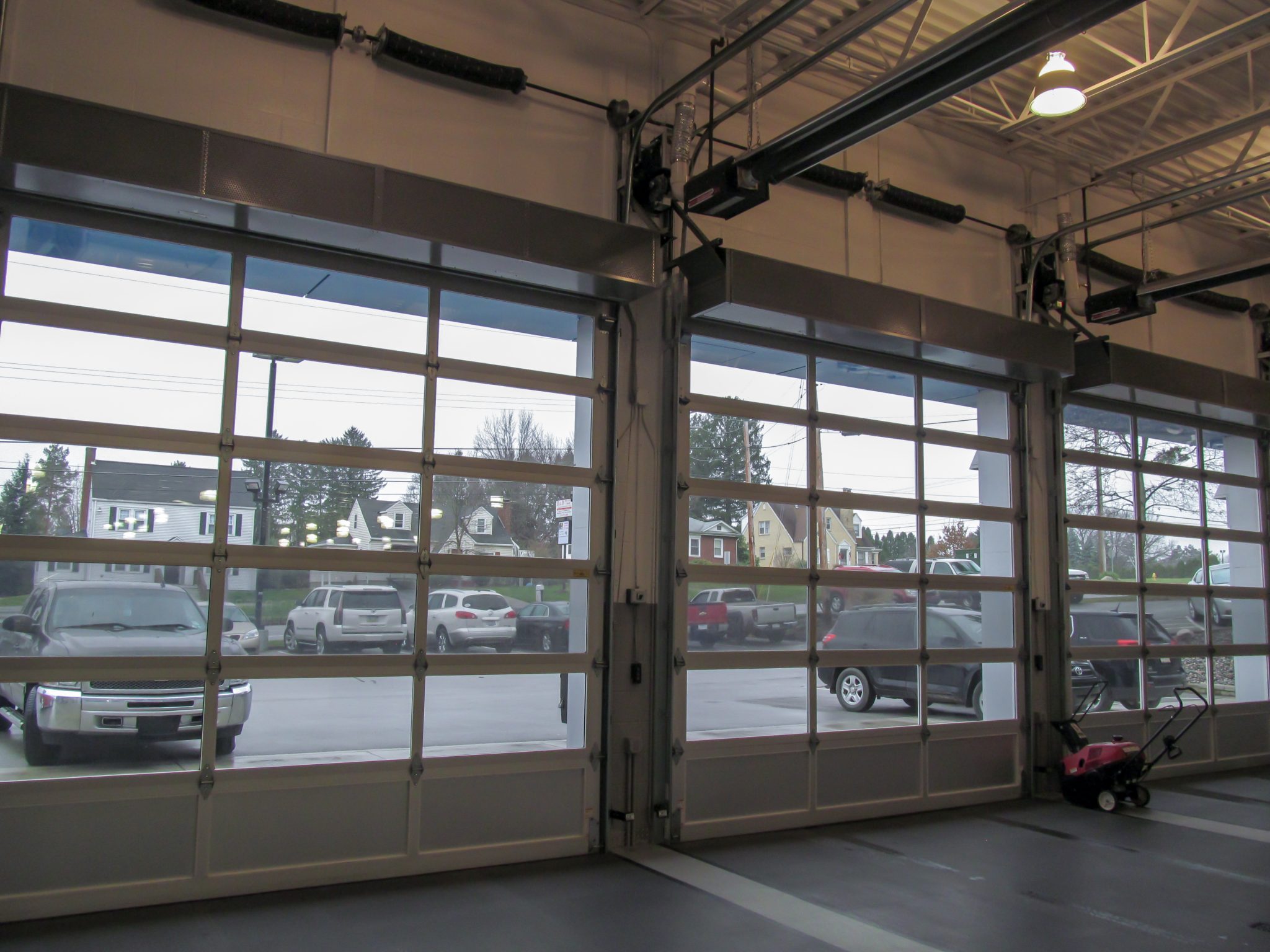 Berner's Industrial Direct Drive 12 Air Curtains over car dealership service garage doors.