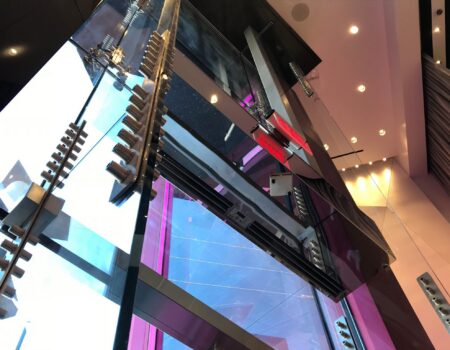 Berner Industrial Direct Drive 12-14 air curtain mirrored stainless steel over T-Mobile entrance.